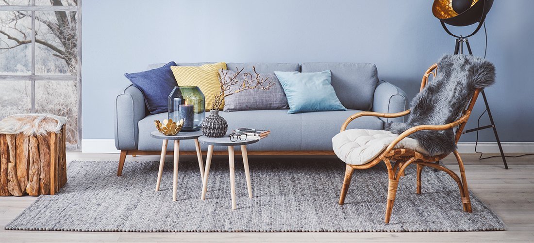Modernes Wohnzimmer mit blauen Möbeln: Sofa und Sideboard in Trendfarbe Blau, gemütliches skandinavisches Ambiente.